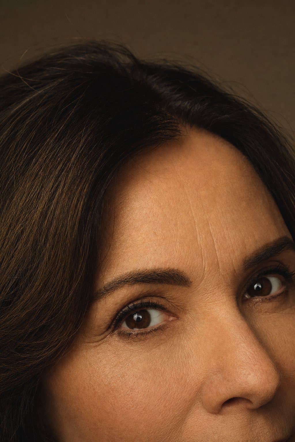 Close crop of bright, rested eyes and brow in warm light. Illustrative image — not a patient.