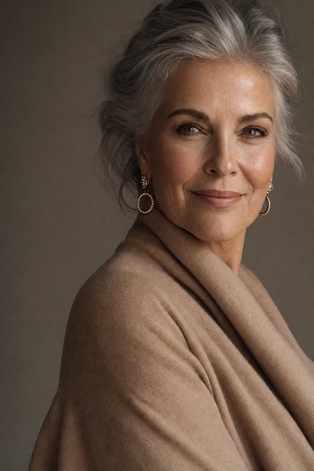 An elegant woman in her sixties, silver hair styled, poised warm expression in sculptural light. Illustrative image — not a patient.