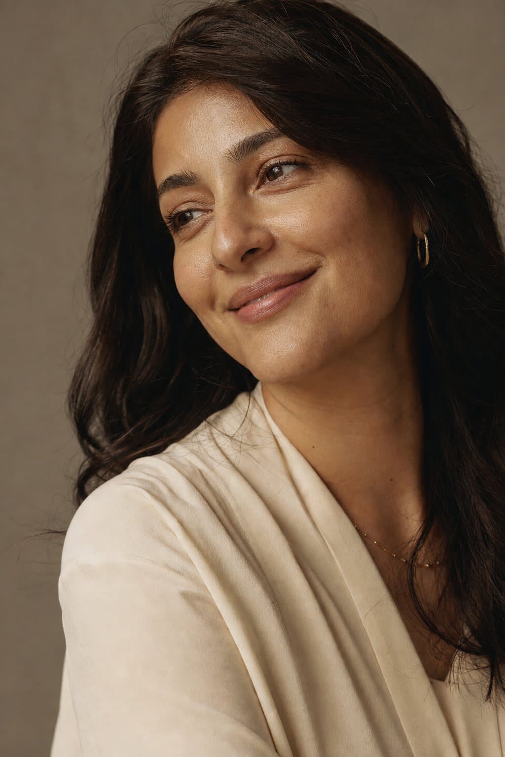 Warm portrait, genuine smile of self-recognition. Illustrative image — not a patient.