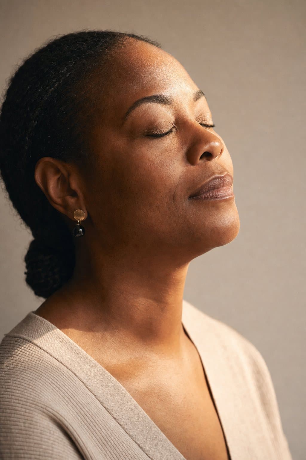 Eyes gently closed, deep quiet relief, warm light. Illustrative image — not a patient.
