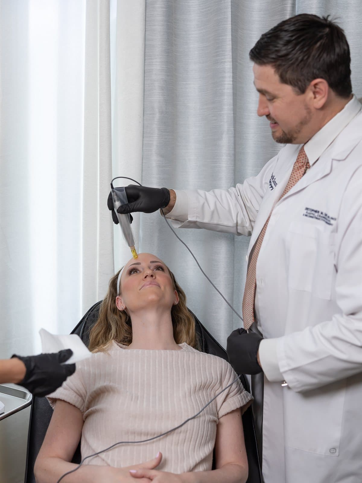 Dr. Day performing a microneedling treatment at the Pacific Sound medical spa