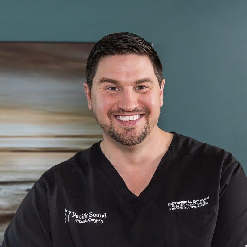 Dr. Kristopher Day in scrubs at the practice's reception in Bellevue